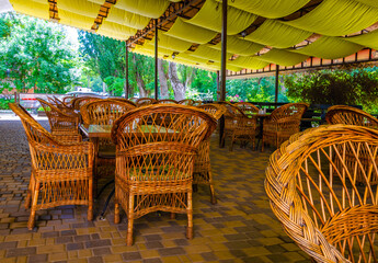 The veranda of the summer cafe with wicker chairs.