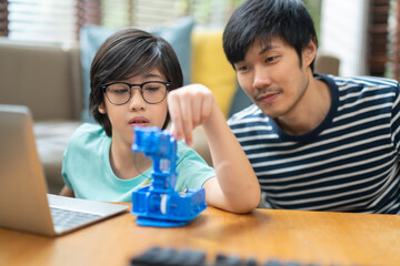 Concept of study at home,coding control robotics and home school.asian boy child with father...