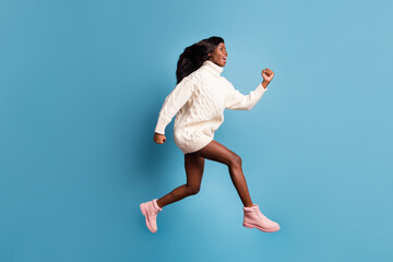 Photo of purposeful dark skin woman dressed white winter clothes running fast isolated blue color background