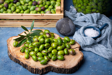 Homemade crushing olive making. Fresh green olives are breaking one by one. Crushing olives with stone. Preparing pickled olives in Turkish style. (Turkish name; kirma zeytin)