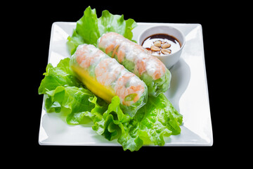 vietnamese cuisine, white plate, spring rolls on lettuce leaf, on black isolated background, top