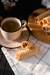 cup of tea and wafer rolls