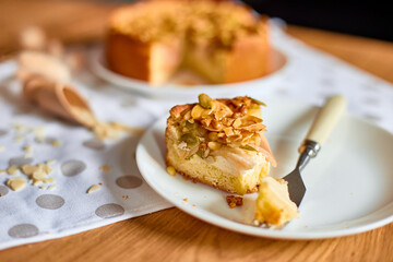 Piece of apple or pear pie, tart with caramel nuts on wooden table, copy space, top view.