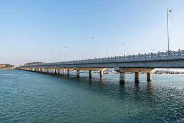 Fototapeta na wymiar Long seaside bridges span the sea