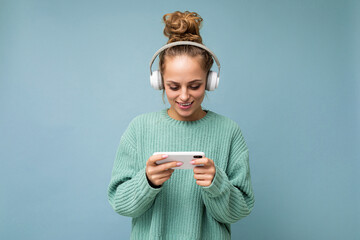 Photo shot of beautiful joyful smiling young female person wearing stylish casual outfit isolated...