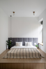 Bed at home interior, apartment bedroom design.