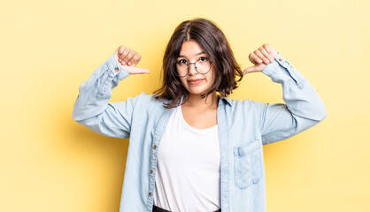 young pretty girl feeling proud, arrogant and confident, looking satisfied and successful, pointing...