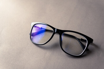 black frame blue light blocking technology anti glare spectacles glasses on grey background