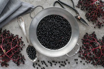 Black elderberry berries in metal plate