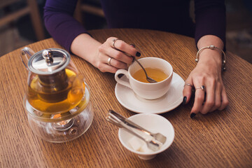 close-up woman drinking tea. Teapot, a cup of tea, tea interferes