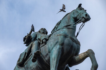 Pigeons and the questrian statue of Charles III, in the square of the Puerta del Sol. Madrid. Spain.