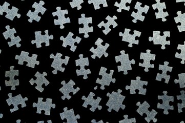 The puzzle elements are randomly scattered on a black background