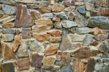 A detailed picture of a stone wall. Old stone wall texture background for design and decor. High...