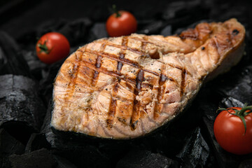 Grilled salmon fish on coals
