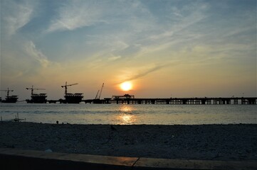 MALE ISLAND, MALDIVES - JANUARY 06,2018: a sunset view of bridge under construction for background, cranes, selective focus