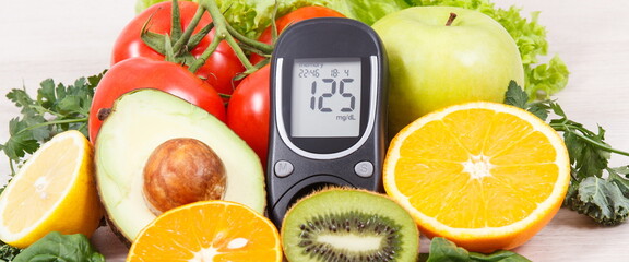 Glucometer with sugar level and healthy fruits and vegetables. Nutritious food containing minerals and vitamins during diabetes