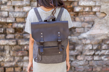 Back of woman with gray canvas backpack