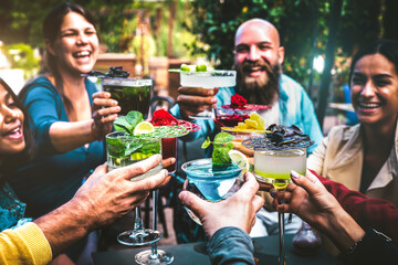Fashionable people holding multicolored drinks - Trendy friends having fun together drinking...