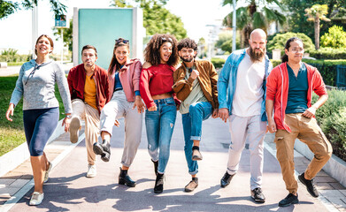 Multiethnic friends walking at seaside acting stupid funny moves - Happy guys and girls having fun...