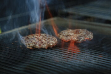 Fresh tasty burger on dark background - Hamburgers cooking on grill