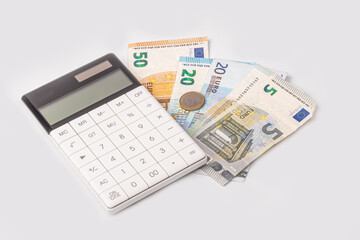 money, euro, white calculator. the concept of buying and maintaining a house, apartment, credit relations, loan