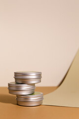 Aluminum round jar for cosmetics. Metalic cosmetic bottles. Blank mock up advertising container with copy space.