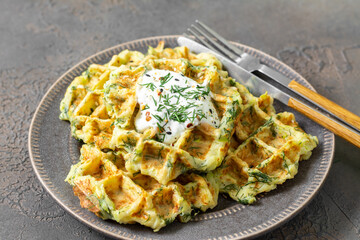Homemade zucchini waffles in a plate on a culinary background closeup	