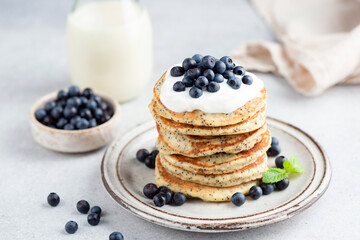 Stack of lemon poppy seed pancakes topped with yogurt and blueberries. Healthy breakfast food, low sugar pancakes - 458569408