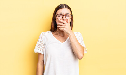 hispanic pretty woman yawning lazily early in the morning, waking and looking sleepy, tired and...