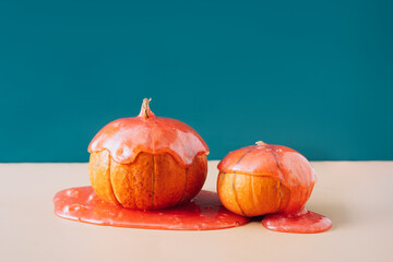 Two beautiful orange pumpkins in red slime