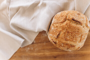 Homemade sourdough bread. Bread on a cutting board. Make real bread. Homemade food. Cooking food. Coronavirus covid-19 in home isolation quarantine.