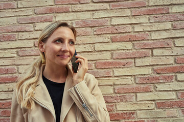 Attractive woman taking a phone-call outdoors