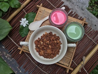 Obraz na płótnie Canvas Granola mixed nuts with pink and green milk