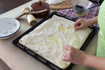 woman making pies on the table in the kitchen