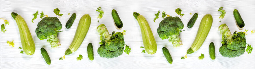 Banner of healthy green vegetables. Broccoli, zucchini and cucumbers on white background