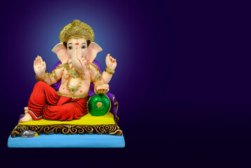 Hindu God Ganesha on colorful background, with copy space, Ganesha is the patron of arts and...