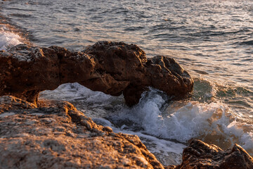 Obraz premium Stones on the seashore. Rocky beach at sunset. Natural background.