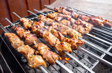 Russian shashlik with skewers on a round grill.