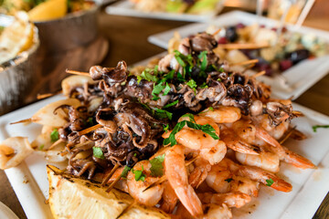 Selective focus of octopus and shrimp seafood appetizers on plate