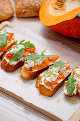 grilled ciabatta bruschetta with baked pumpkin, feta arugula and spices. healthy fall baked pumpkin snack