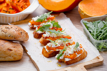 grilled ciabatta bruschetta with baked pumpkin, feta arugula and spices. healthy fall baked pumpkin snack