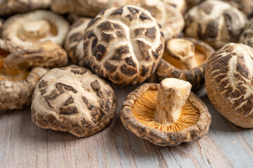 Dried shiitake mushroom on wooden background. Healthy food.