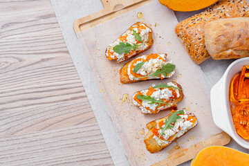 grilled ciabatta bruschetta with baked pumpkin, feta arugula and spices. healthy fall baked pumpkin snack