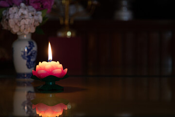 Closeup shot of a candle with lotud flower shape