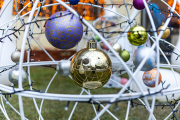 street Christmas decorations: a wreath with balls and garlands