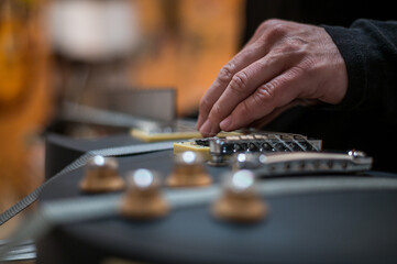 Black electrical guitar in a service repair workshop