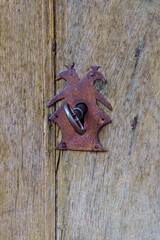 Key inside the lock of an old wooden door