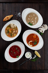 Assortment of soups in a restaurant menu: mushroom cream soup, peasants' soup, borsch and chicken soup