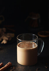 A cup with masala chai in low key