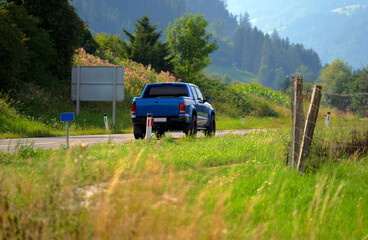 Cars running on the beautiful road along the mountain, Rear view of pickup truck on wavy road - obrazy, fototapety, plakaty